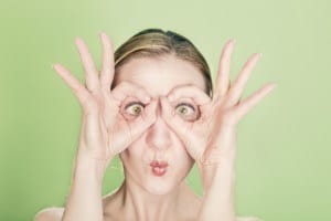 Funny face woman reminding you to see your eye care specialist once a year.